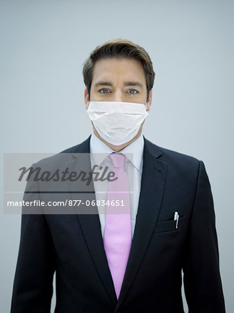 Businessman wearing swine flu mask