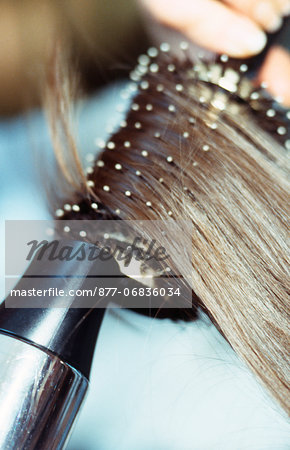Close up of hairdryer and mesh on hair brush
