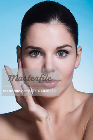 Young woman with hand on cheek