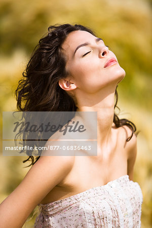 Portrait of young woman wih head back, eyes closed