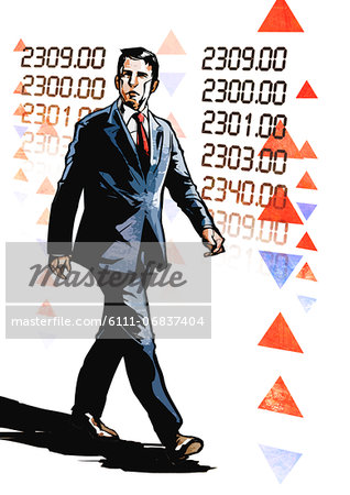 Businessman walking in front of trading screen