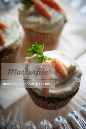 carrot muffins with cream cheese icing and marzipan carrot decorations