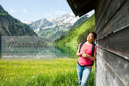 Mature Woman Standing by Wooden Building, Vilsalpsee, Tannheim Valley, Tyrol, Austria