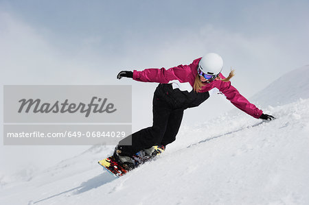 Young woman snowboarding