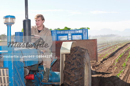 Young man driving tractor