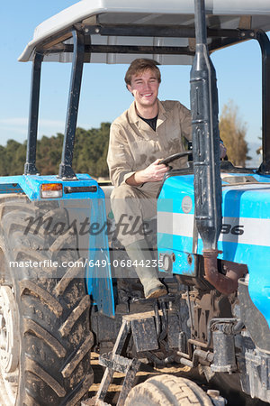 Young man driving tractor