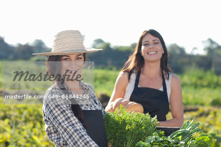Women with vegetables grown at farm