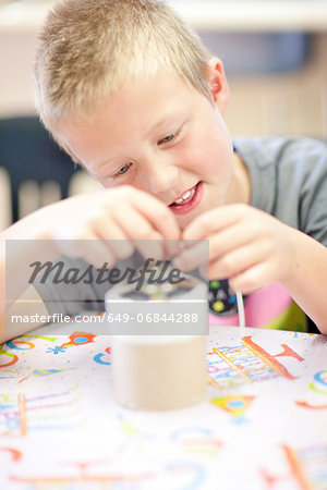 Boy making craft object