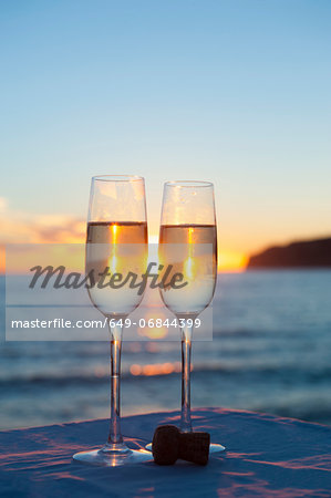 Two wine glasses with sea in background