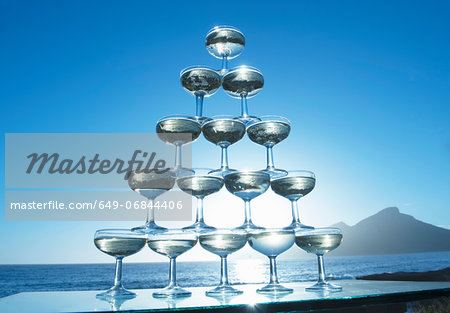 Champagne glasses in pyramid shape with sea in background