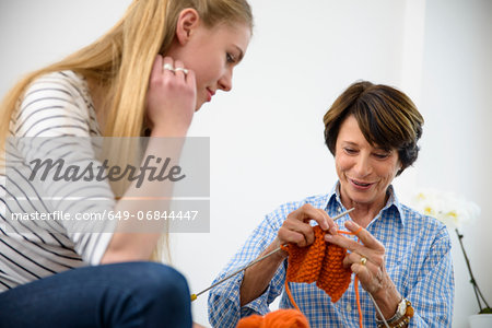 Mother teaching daughter kitting