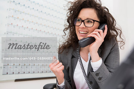 Businesswoman on telephone call, smiling