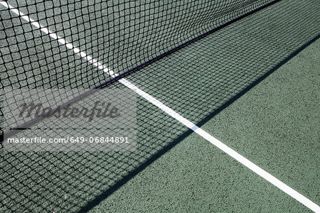 Tennis net on court at day time Tennis net on court at day time