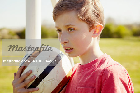 Boy with ball looking into the distance