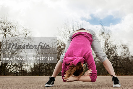 Woman doing bending forward exercise