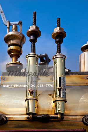 Pair of old brass gauges on a traction engine