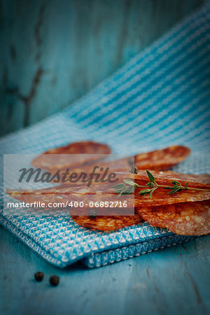 Chorizo salami sausage on blue rustic background. Meat cold cuts.