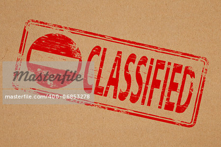 Classified rubber stamp symbol on brown paper background
