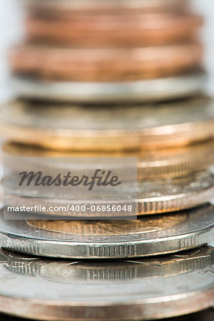 Stacks of coins white isolated studio shot