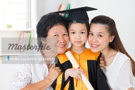 Kindergarten graduation. Happy Asian family, grandparent, parent and grandchild on her kindergarten graduate day.