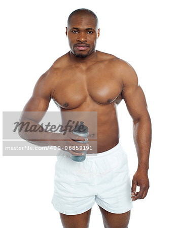 Athlete posing with health drink bottle isolated over white