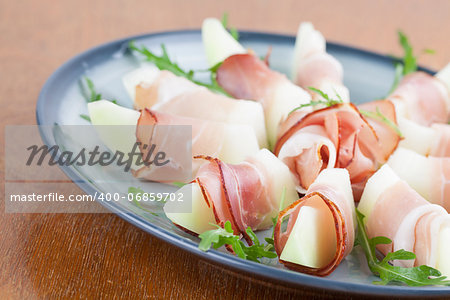 Prosciutto and honeydew melon appetizers with arugula