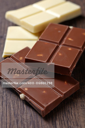 pieces of white and milk chocolate on brown wooden table