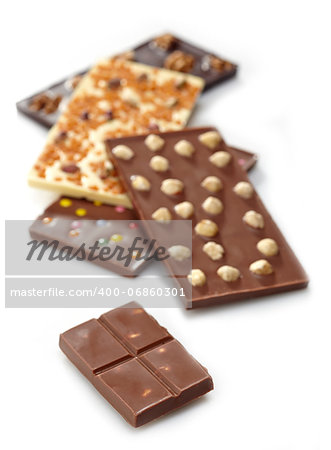 Various chocolate bars with nuts on white background