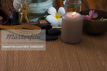 tropical spa setup with frangipani flower hot rocks and massage items