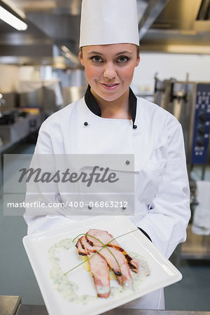 Chef presenting her plate in the kitchen