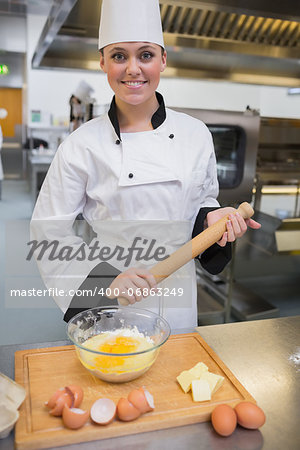 Chef holding rolling pin while making dough in the kitchen