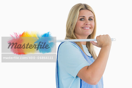 Smiling cleaning woman holding feather duster in the white background