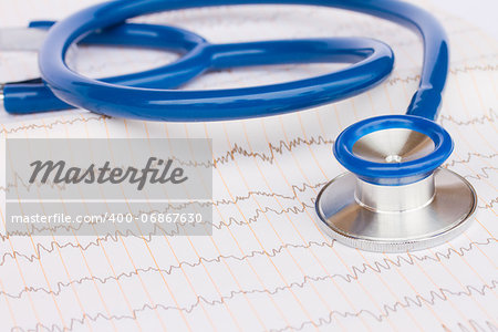 Blue stethoscope laying on ECG results close up