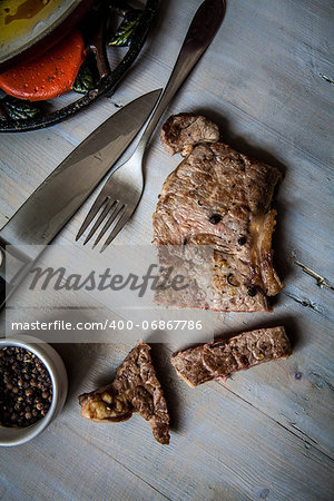 beef steak grilled with pepper on wooden table