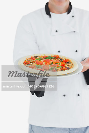 Male chef offering pizza over white background