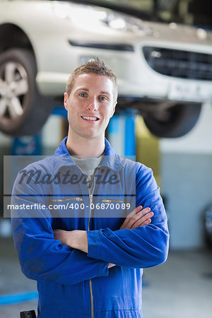 Portrait of confident male mechanic with arms crossed