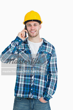 Portrait of young male architect using cellphone over white background