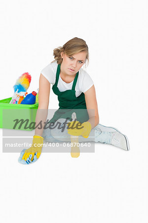 Portrait of young maid cleaning floor over white background