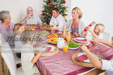 Family having christmas dinner together at table in kitchen