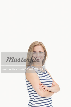 Portrait of happy confident casual woman with arms crossed over white background