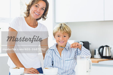 Mother and son having breakfast in kitchen