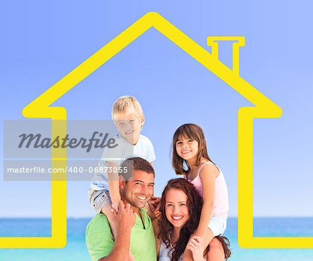 Smiling family posing with a yellow house illustration and the sea behind them