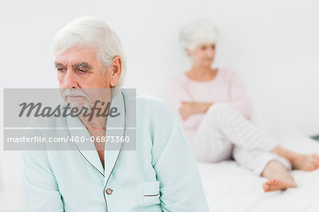 Elderly couple not talking to each other in bedroom