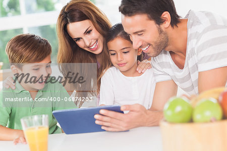 Family using a tablet pc in kitchen