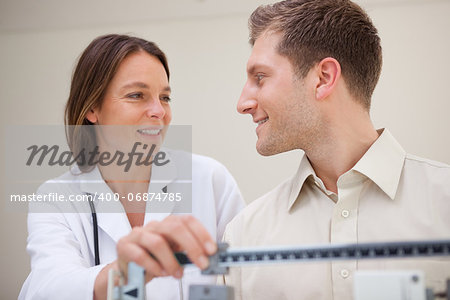 Doctor and patient talking about weight measuring results