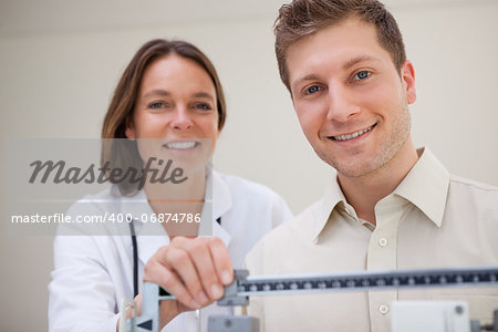 Patient getting scale adjusted by doctor