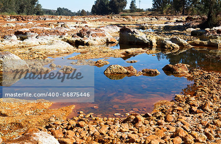 big stones in acidic river Tinto in Niebla (Huelva), Spain