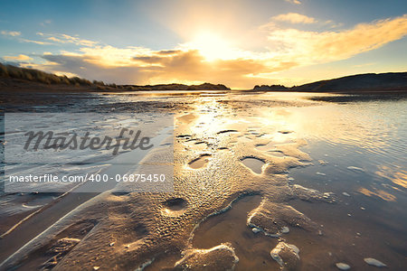 sand beach by North sea at low tide during sunset