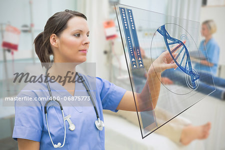 Nurse touching screen displaying blue DNA helix data in hospital ward