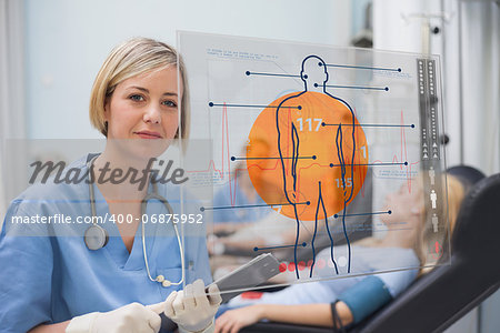 Nurse looking an interface during a blood donation in a hospital